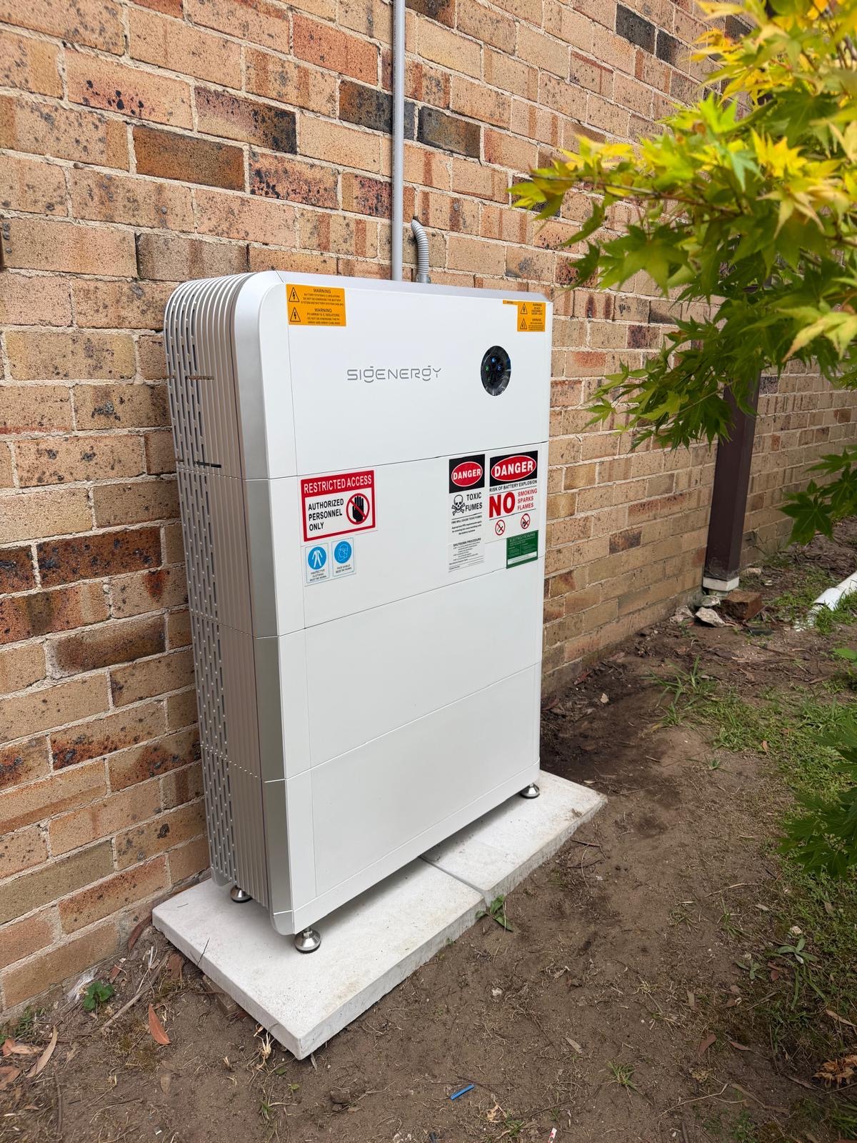 Sigenergy home battery installed against a brick wall
