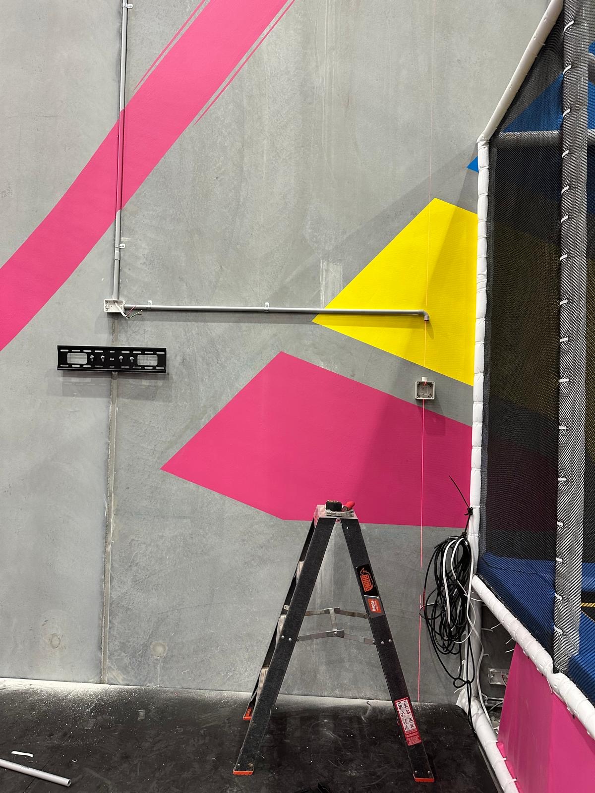 Wall mount and conduit run installed for a shop display screen